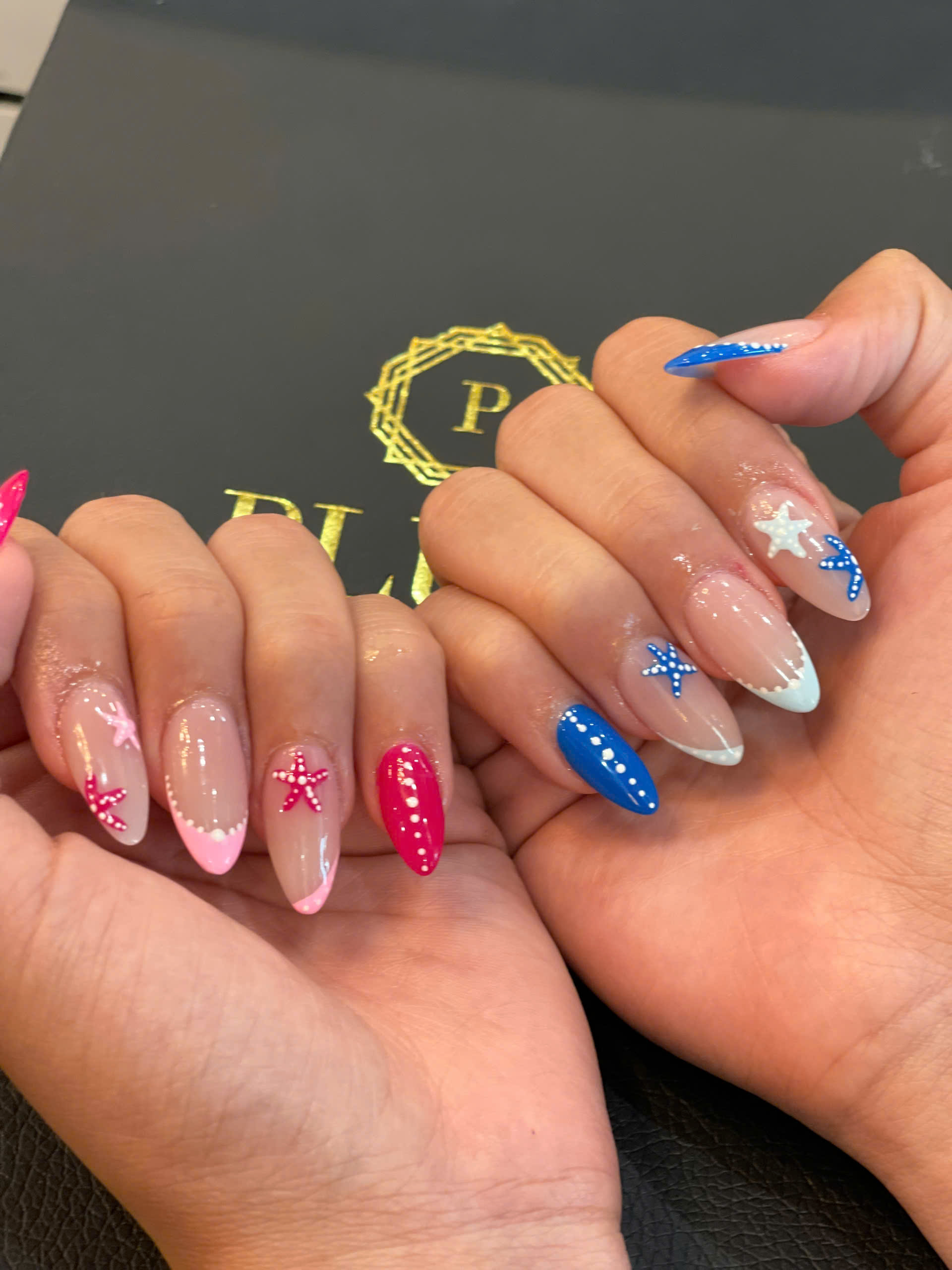 3D French nails with colorful starfish art in red, pink, and blue, featuring bold accents and a fun beach-inspired design for summer.