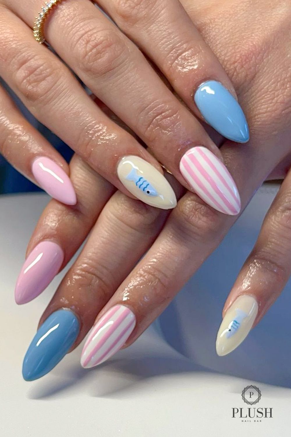3D Nails Are Here to Stay—And We’re Obsessed 2 Pastel 3D nails with baby blue, soft pink, and striped designs featuring a tiny fish detail