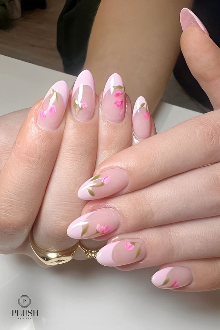 Floral pink nails with hand-painted pink flower details on a nude and soft pink base, pink nail designs, pink and white nails, light pink nails, cute pink nails, natural pink nails, baby pink nails, spring nail art, almond pink nails.